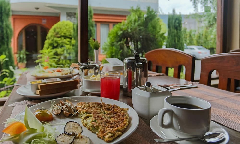 Breakfast of omelette, toast and coffee on the garden veranda
