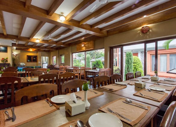 Set tables along the restaurant’s tall windows
