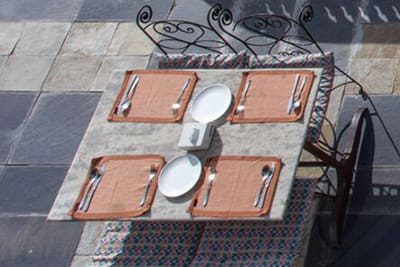 A table for four on the stone-paved terrace, seen from above